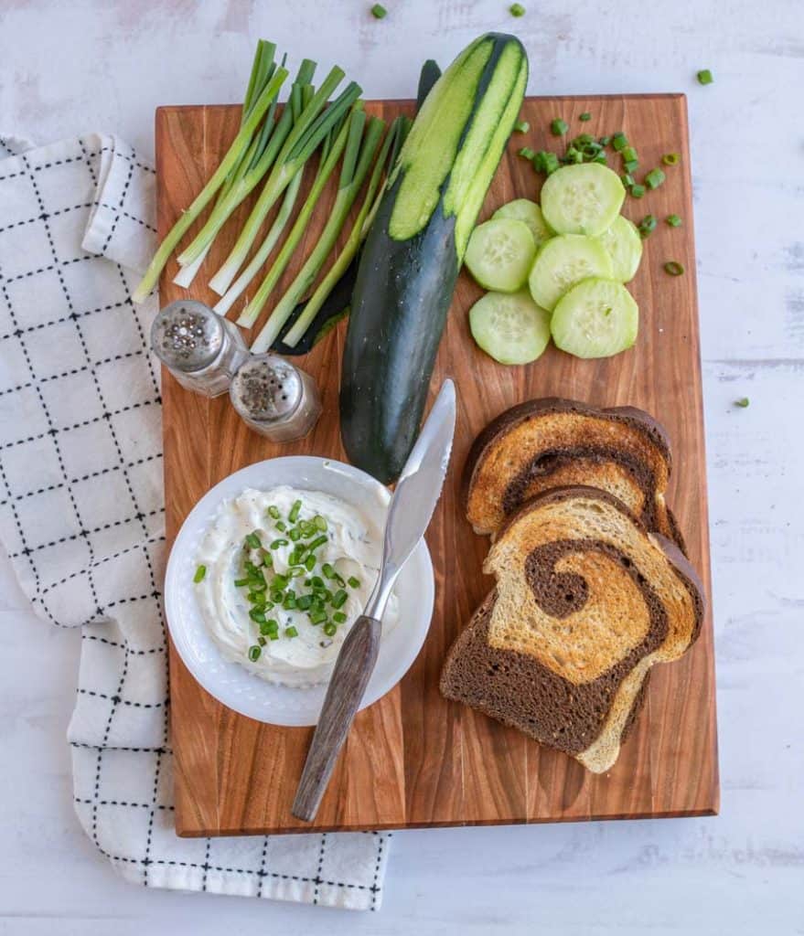 top view of ingredients for cucumber sandwiches on a cutting board
