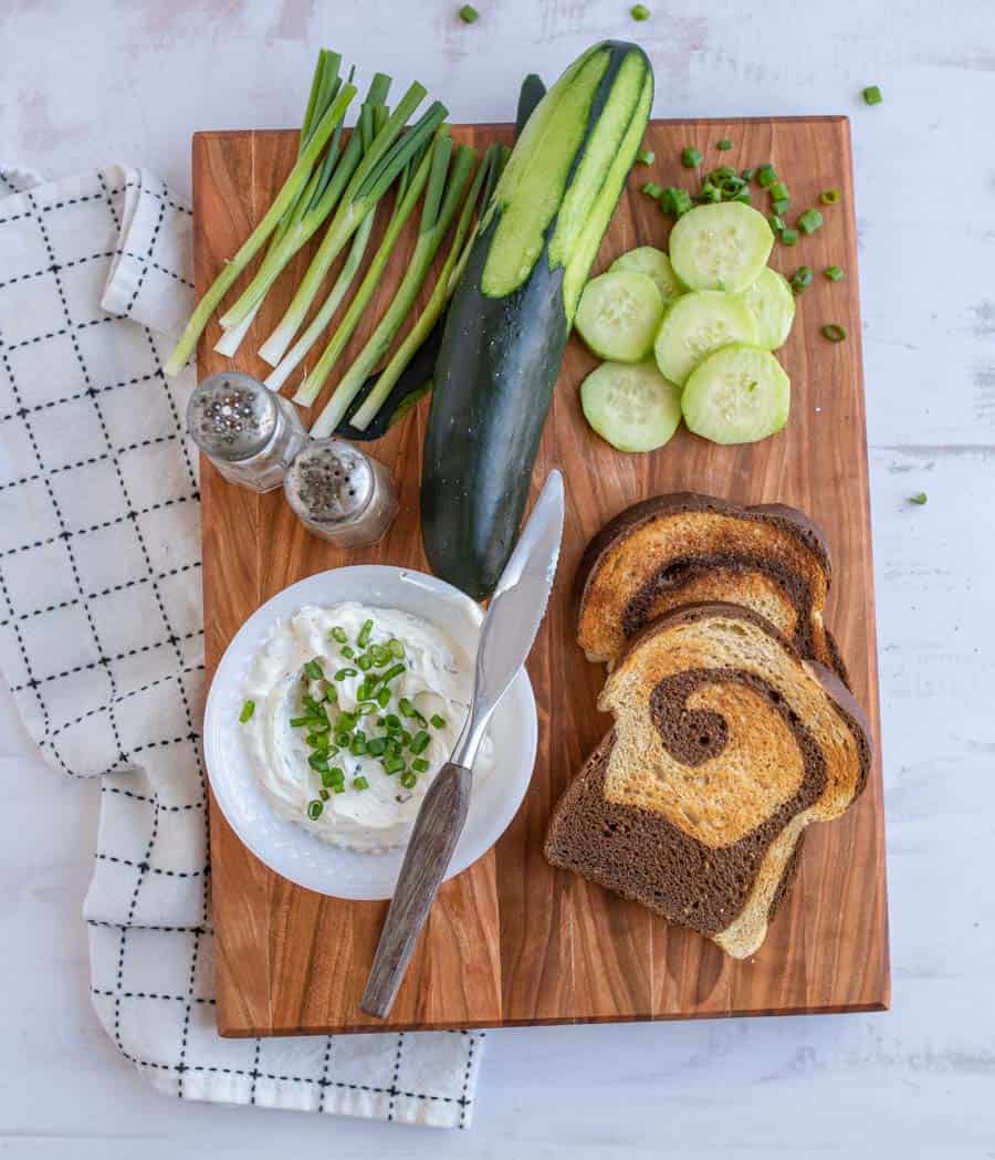 top view of ingredients for cucumber sandwiches on a cutting board