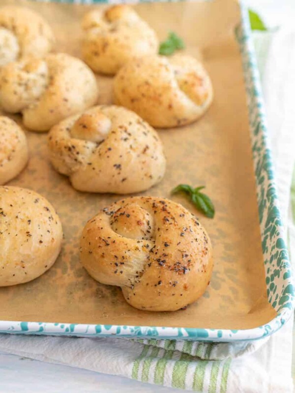 close up picture of garlic knots on a baking sheet