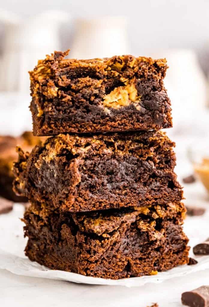 close up of three peanut butter brownie squares stacked on top of each other