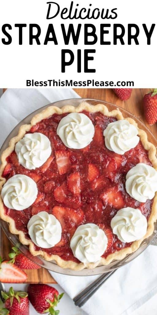 top view of strawberry pie with dollops of whipped cream and the words "delicious strawberry pie" written at the top