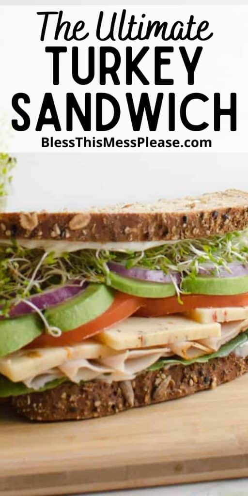 close up front view of a turkey sandwich with the words "The Ultimate Turkey Sandwich" written at the top