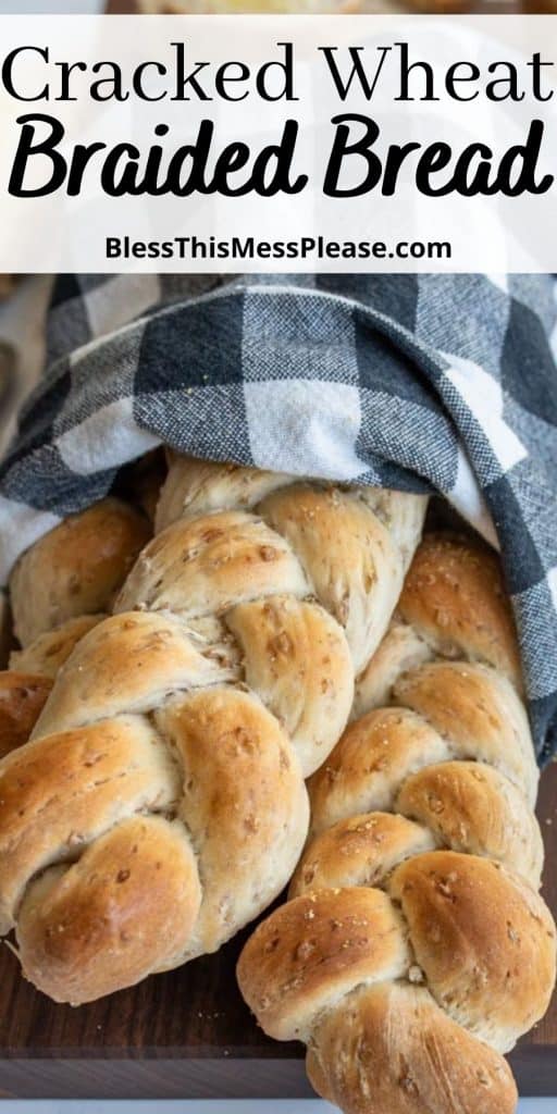 loaves of braided bread wrapped in a towel with the words "cracked wheat braided bread" written at the top