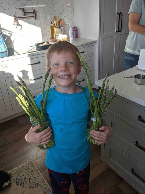 boy holding asparagus
