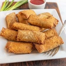 close up of a plate of egg rolls