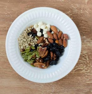 top view of ingredients for trail mix in a bowl