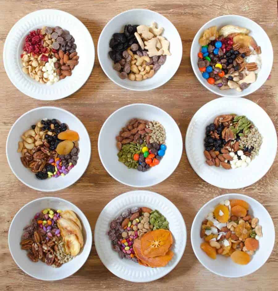 top view of ingredients for trail mix in different bowls