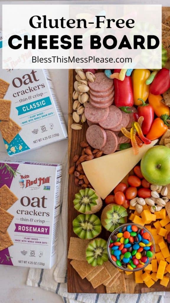 top view of a cheese board with boxes of oat crackers next to the cheese board with the words "gluten-free cheese board" written at the top