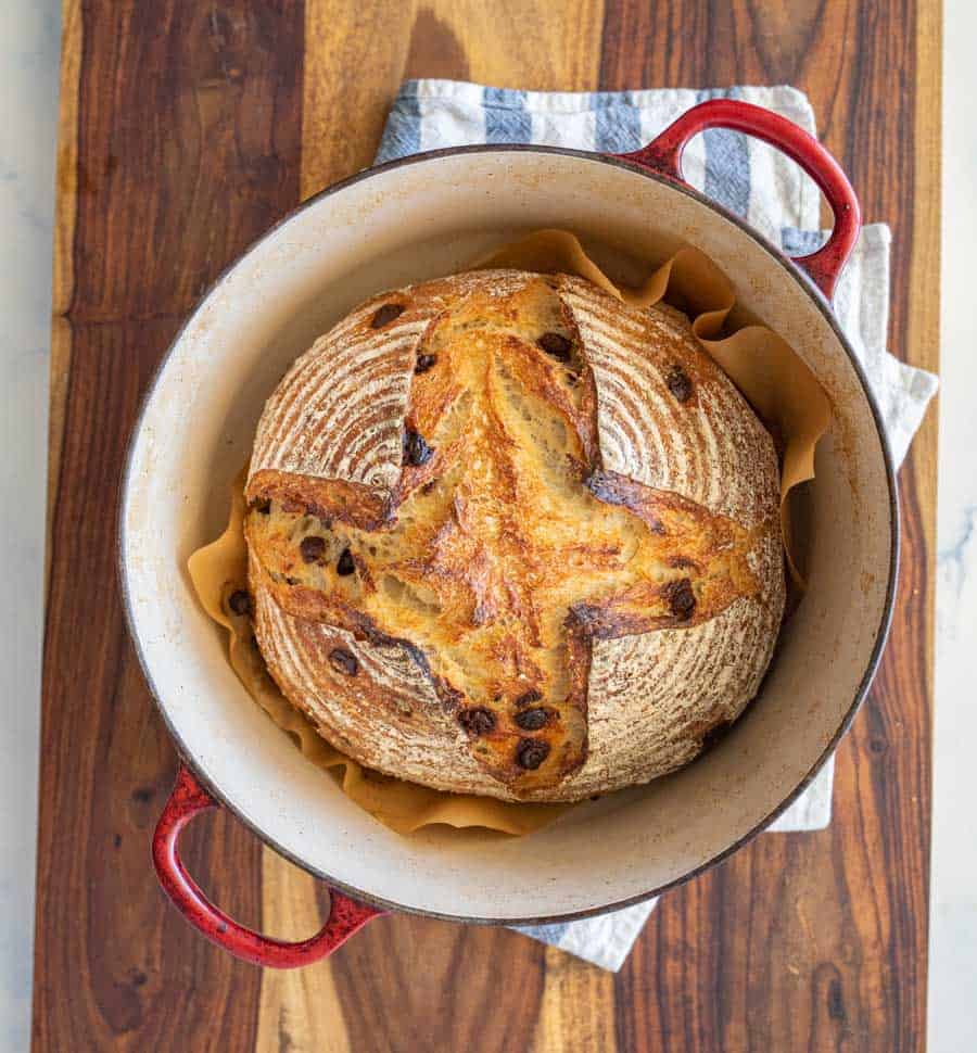 top view of baked chocolate chip sourdough bread in a pot