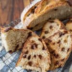 up close picture of slices of chocolate chip sourdough bread with half a loaf in the background