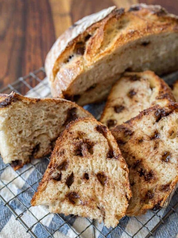 up close picture of slices of chocolate chip sourdough bread with half a loaf in the background