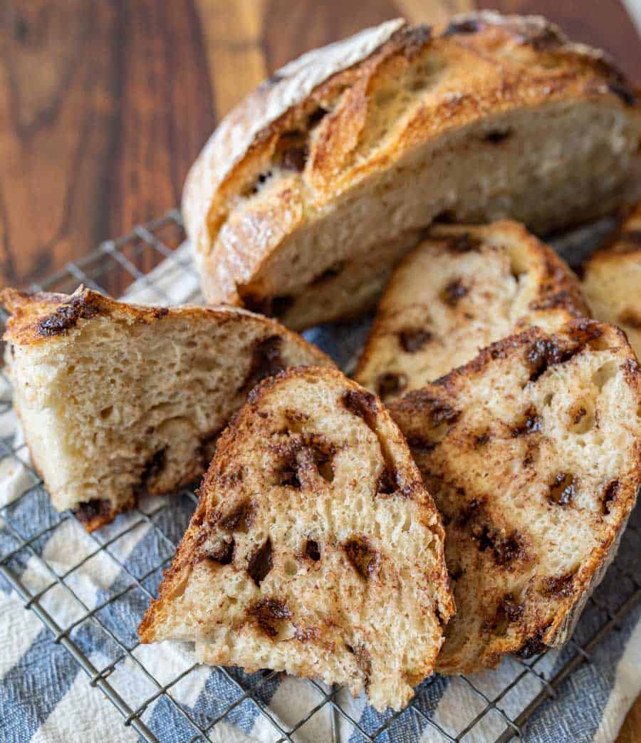 up close picture of slices of chocolate chip sourdough bread with half a loaf in the background