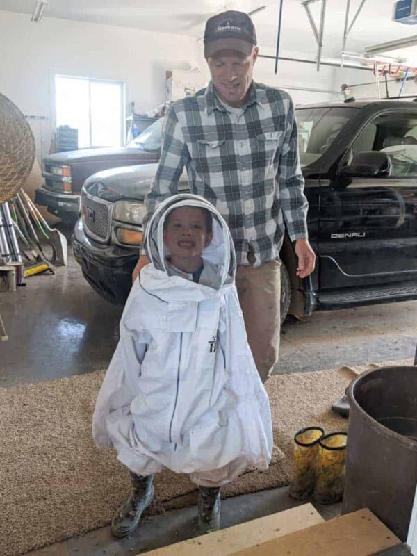 child in an adult bee suit