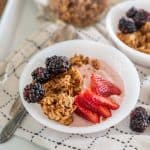 bowls of yogurt with granola and berries on it