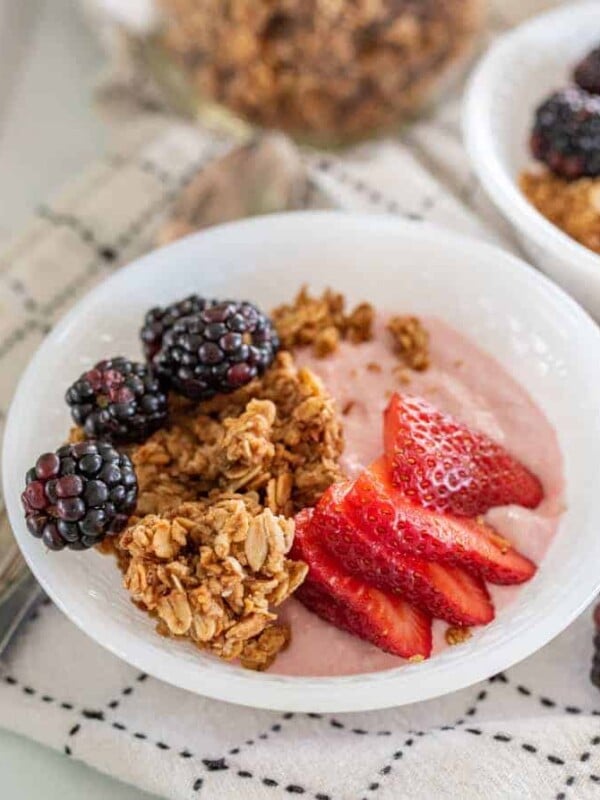 bowls of yogurt with granola and berries on it