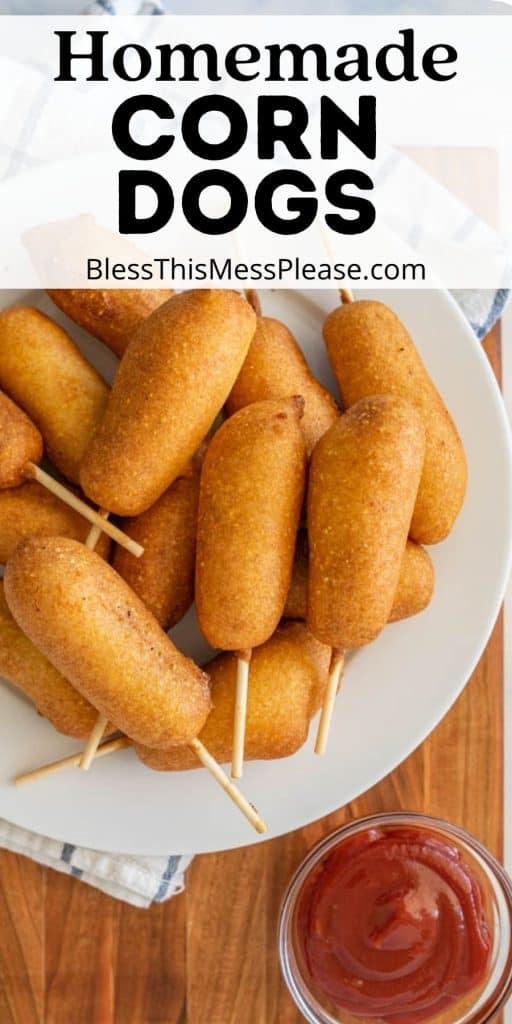 top view of a plate of corn dogs with a bowl of ketchup next to it and the words "homemade corn dogs" written at the top