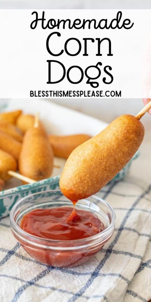 corn dog being dipped into ketchup with the words "homemade corn dogs" written at the top