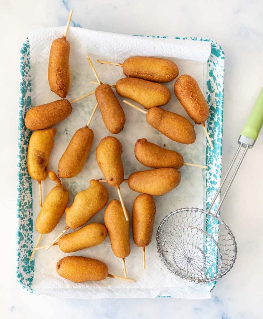 top view of corndogs on a tray lined with paper towel.