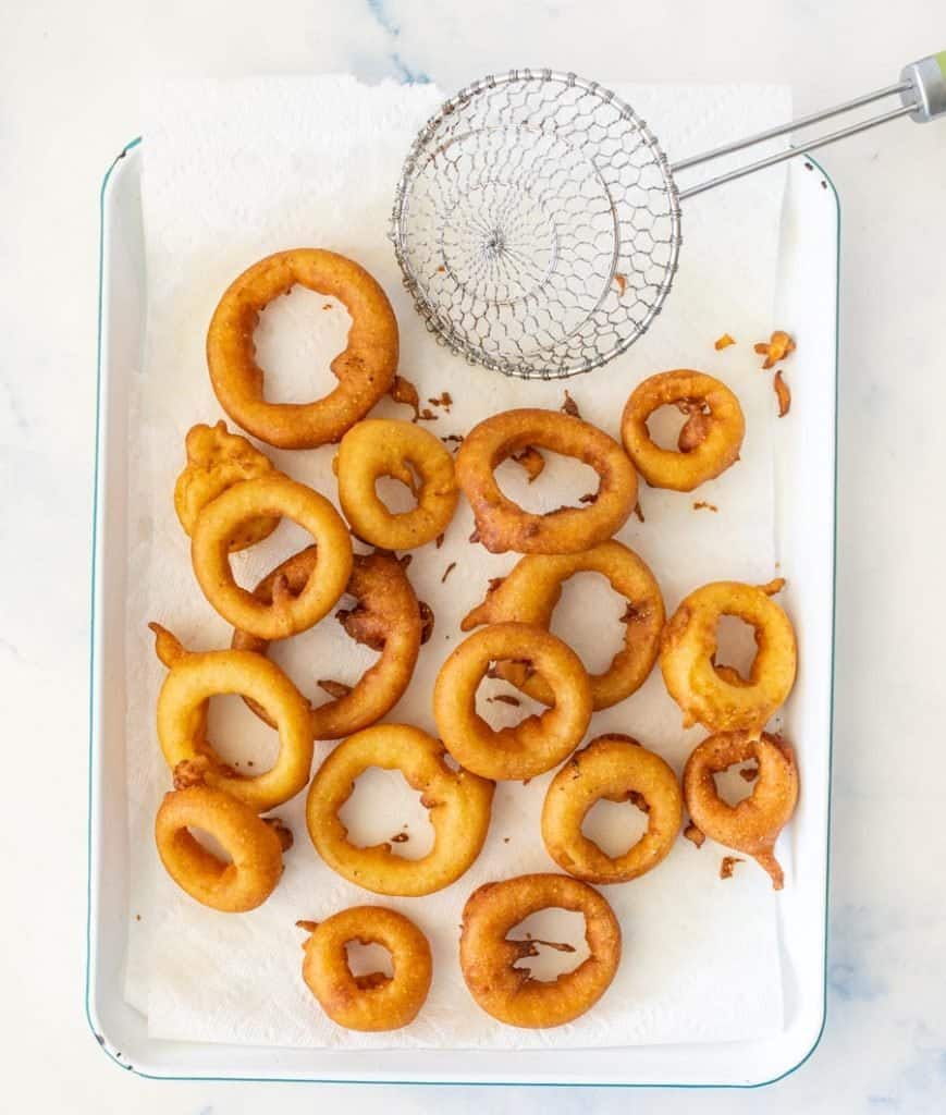 top view of onion rings on a tray lined with paper towels