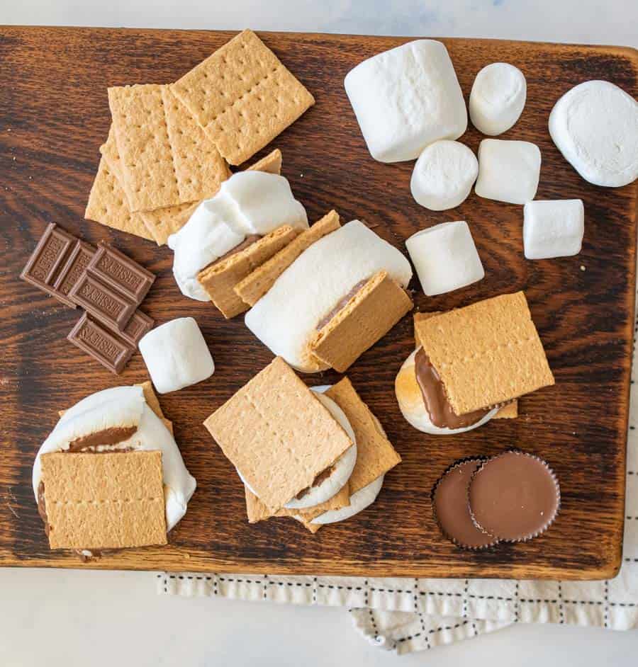Top view of a wood cutting board with ingredients for smores