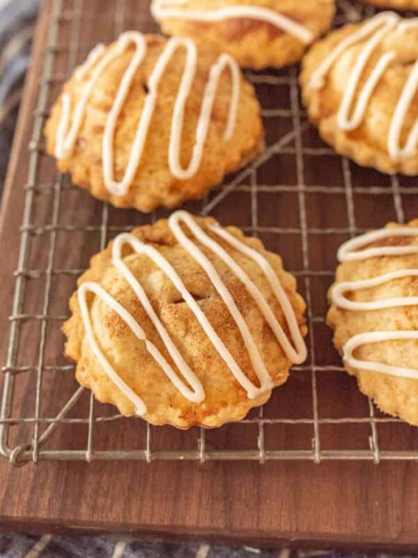 close up picture of apple hand pies on a cooling rack