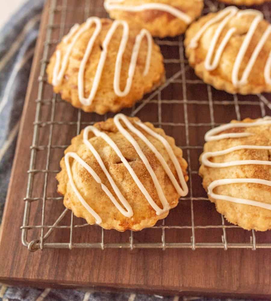 close up picture of apple hand pies on a cooling rack