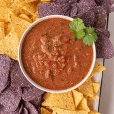 close up of a bowl of blender salsa and chips