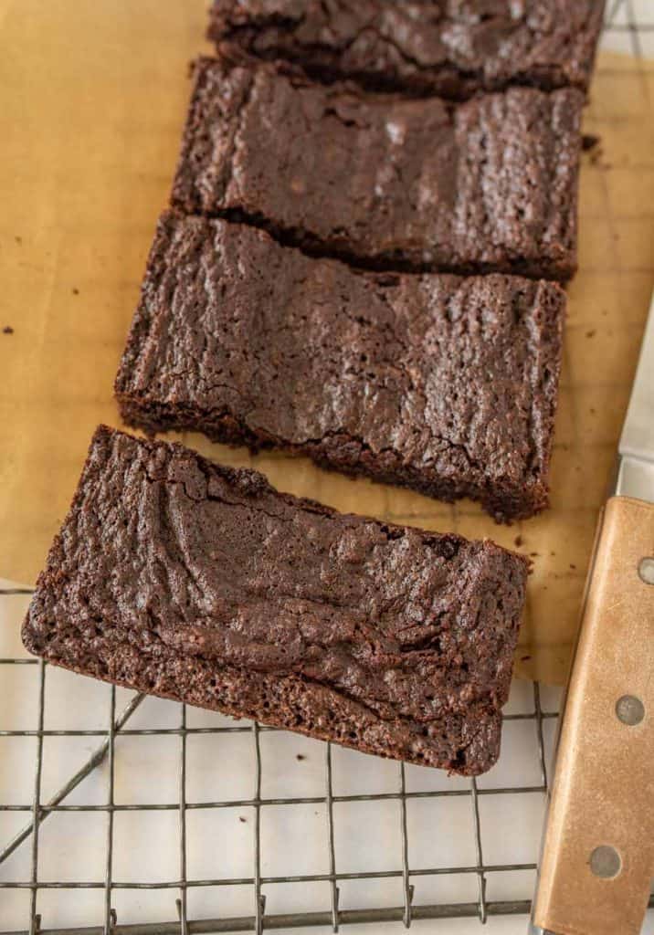 close up of brownies cut into bars on a cooling rack