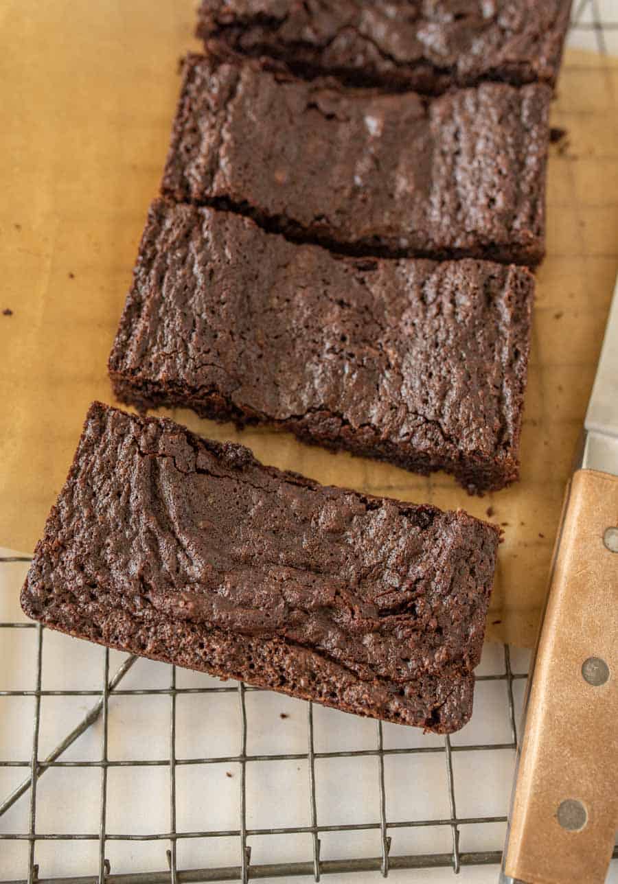 close up of brownies cut into bars on a cooling rack