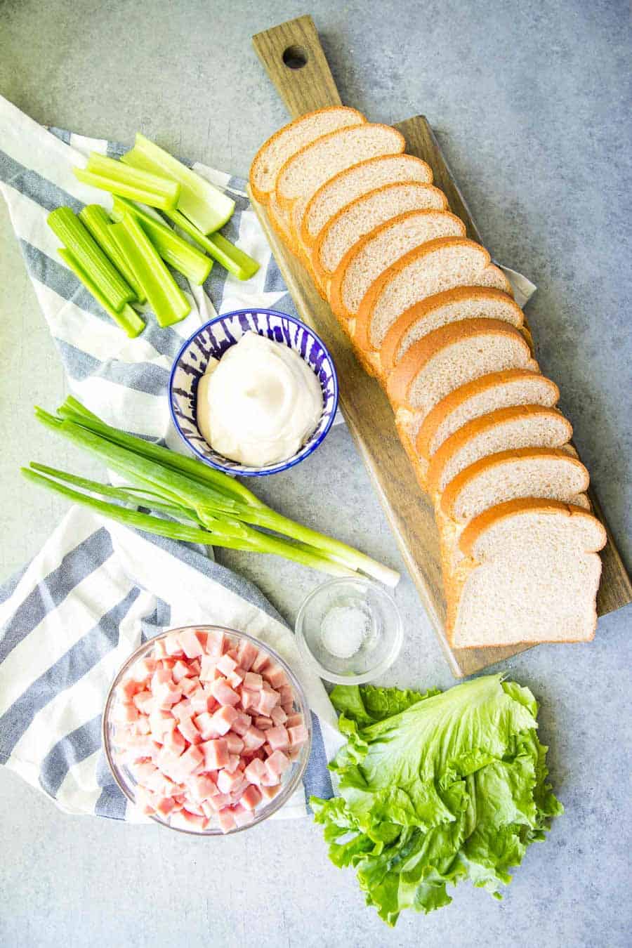 top view of slices of bread and ingredients for ham salad