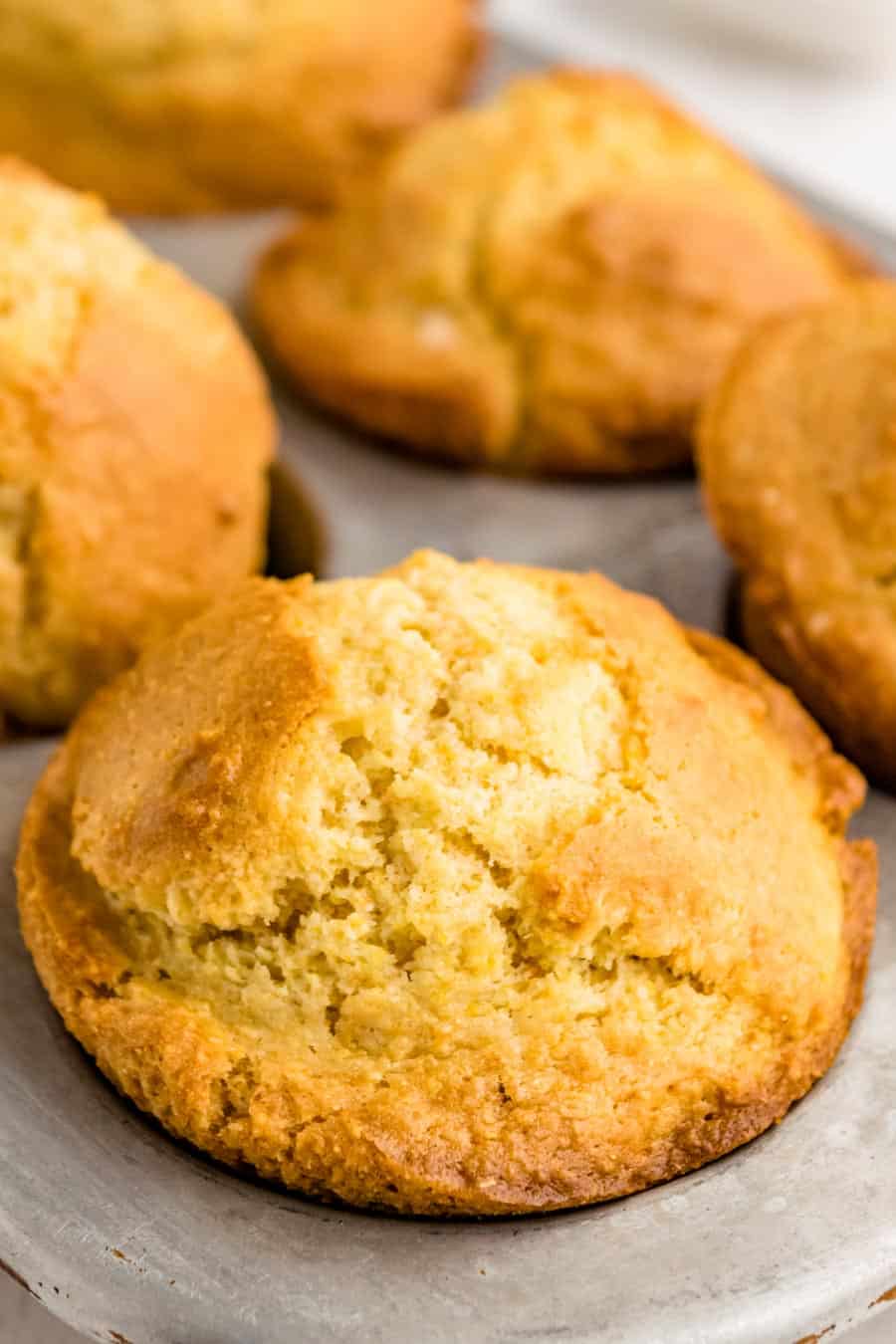 Close up of a corn bread muffin in muffin tin.