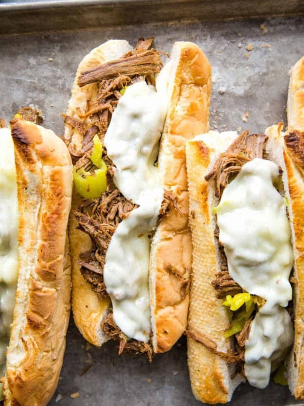 top view of a pan of Italian beef sandwiches with melted cheese on top