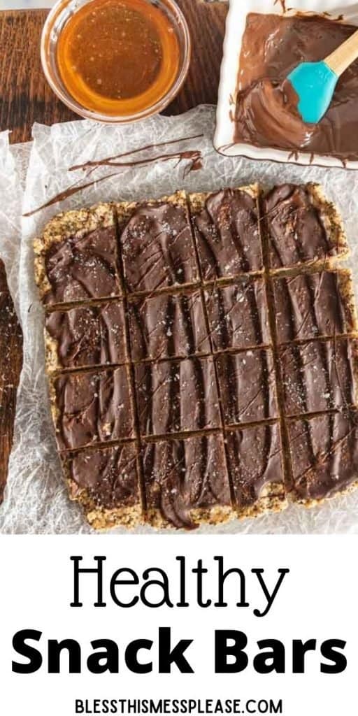 top view of peanut butter protein bars cut into squares with bowls of honey and melted chocolate next to them with the words "healthy snack bars" written at the bottom