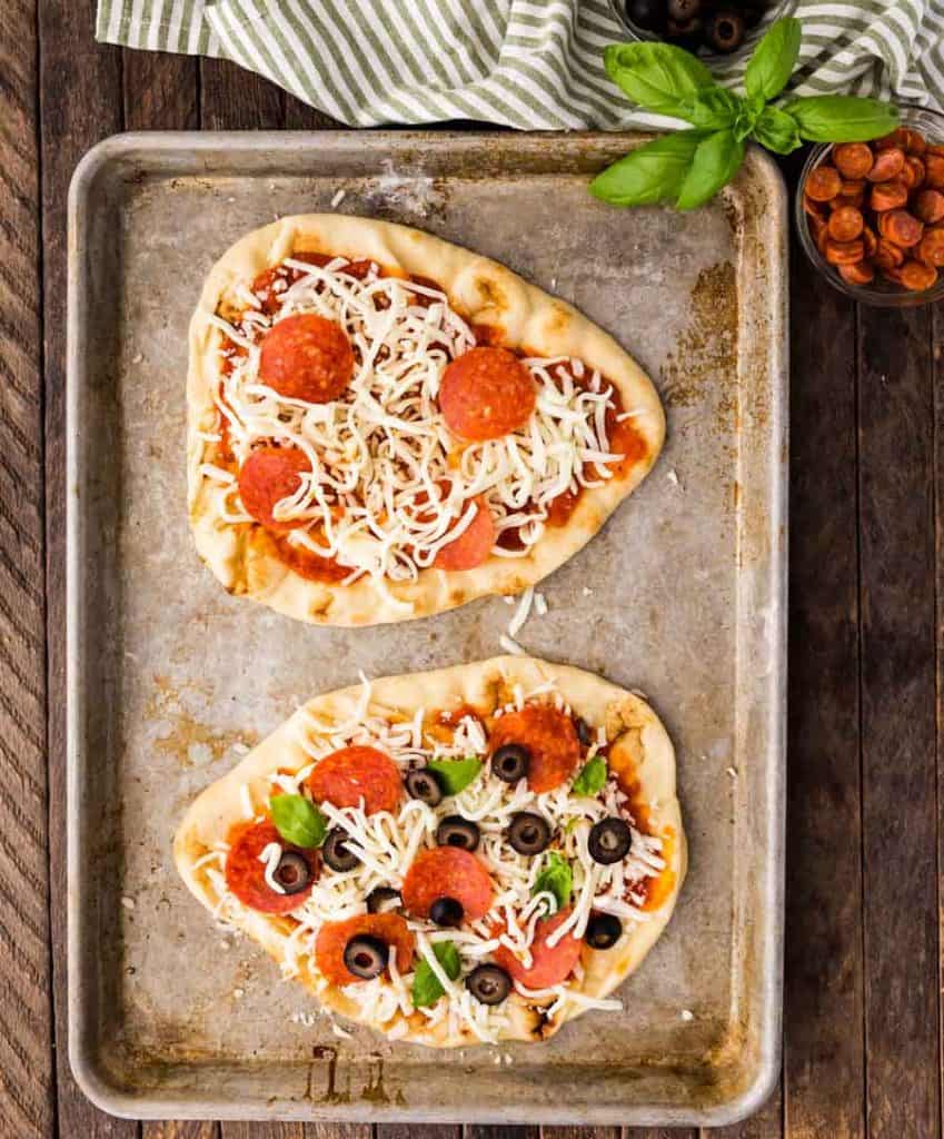 Baking sheet containing two flatbread pizzas
