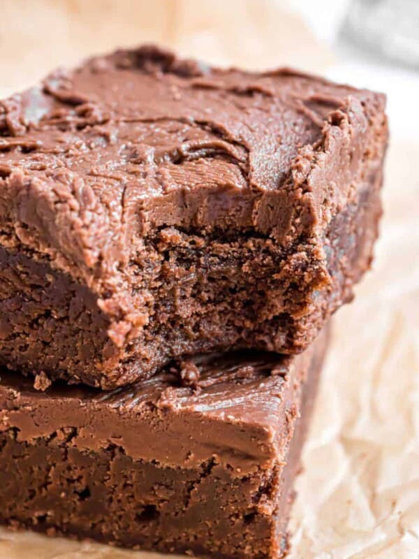 brownie with a bite out of it stacked on top of another brownie