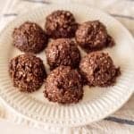 white plate with dark brown chocolate cookie balls