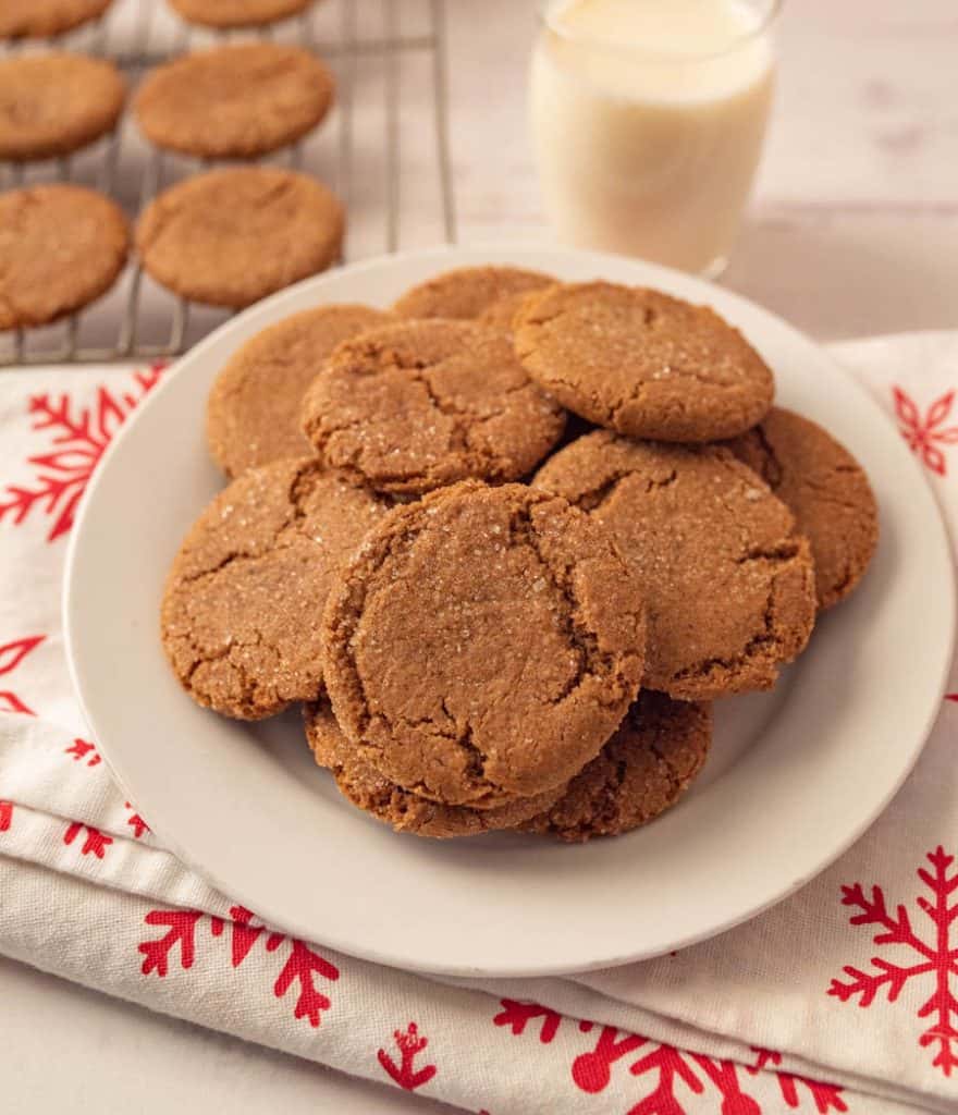 a plate of gingersnap cookies and a glass of milk