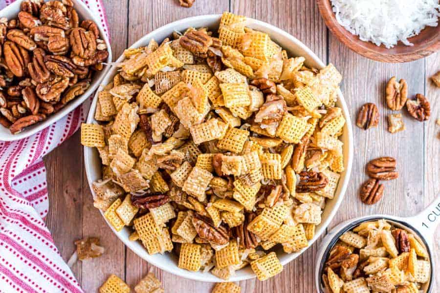 holiday chex mix all together in white bowl.