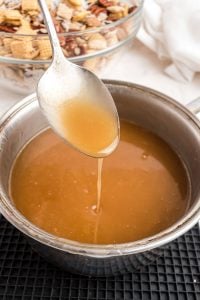 a spoon dripping caramel sauce.