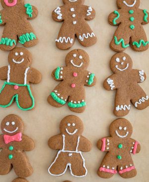 top view of traditionally decorated holiday ginger-people cookies on a sheet pan
