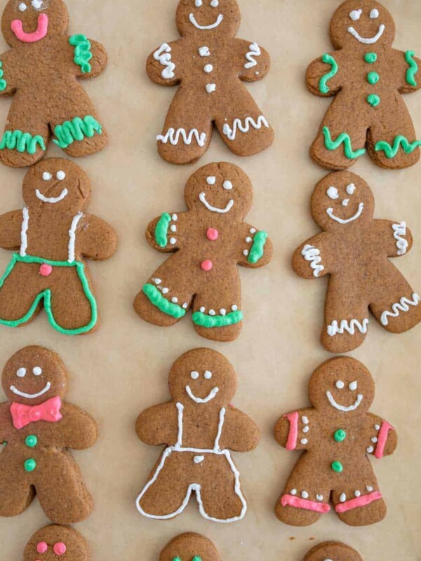 top view of traditionally decorated holiday ginger-people cookies on a sheet pan