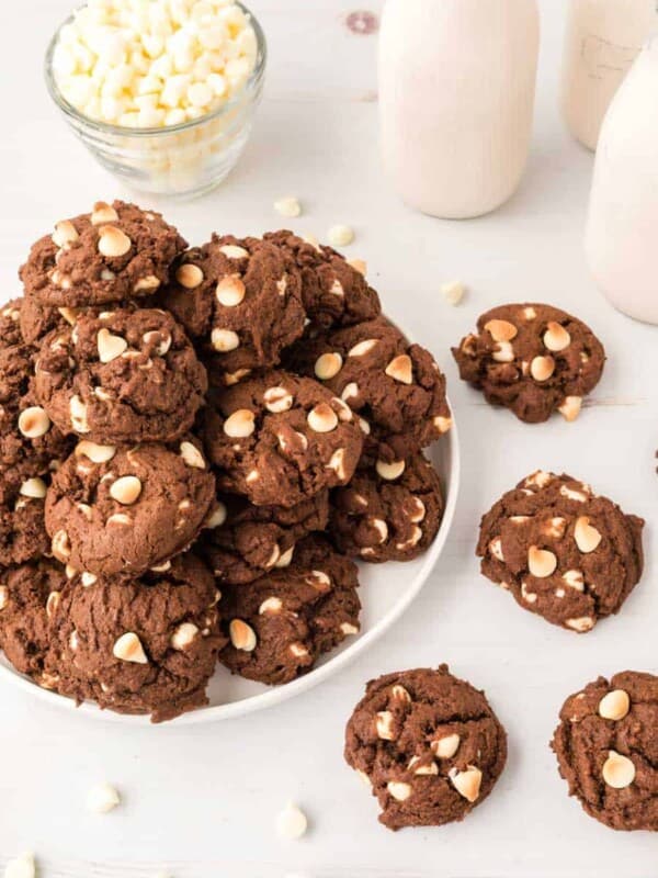 chocolate cookies with white chips piled on a plate.