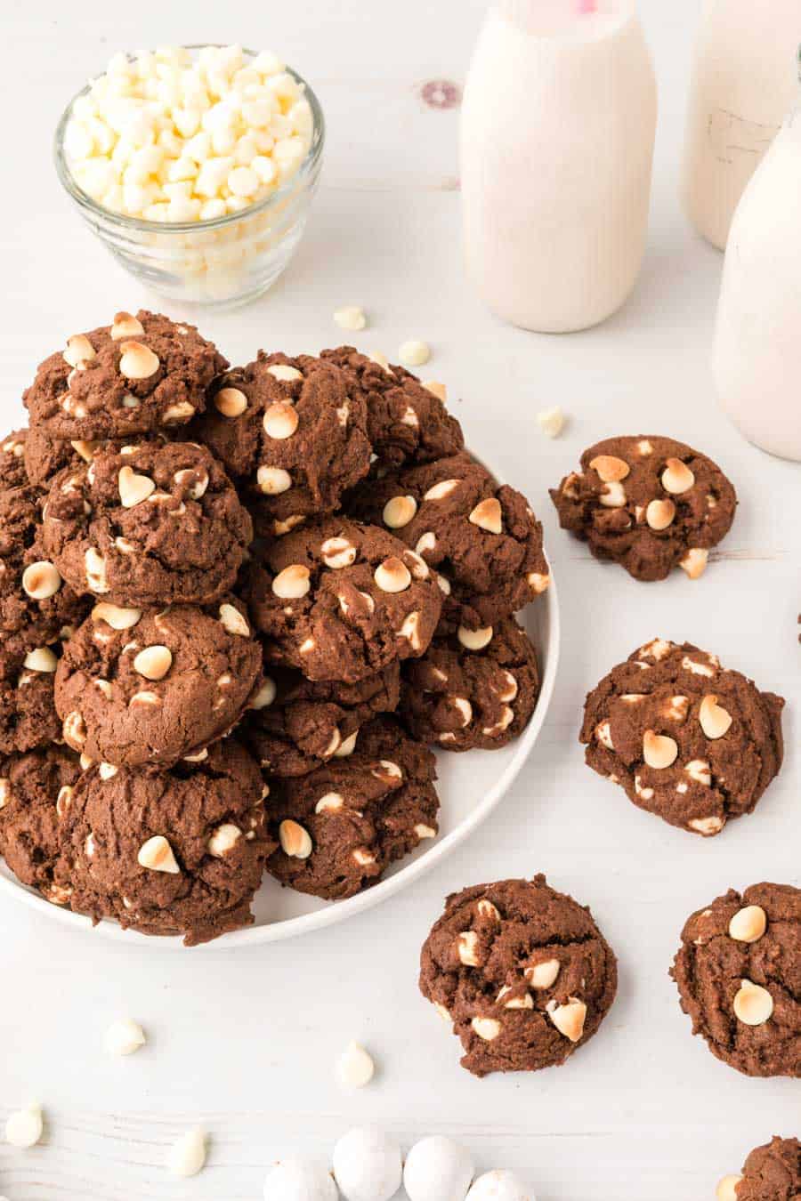 chocolate cookies with white chips piled on a plate.