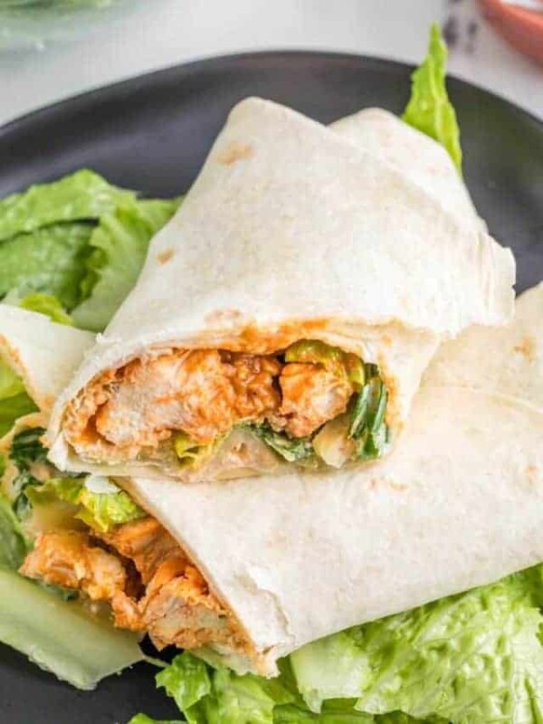 close up of a buffalo chicken wrap sliced in half to look at the inside