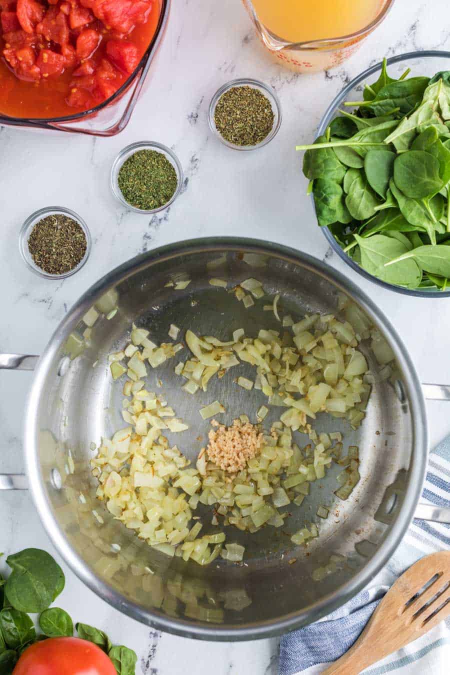 pot with sautéed garlic and spices with onion cooked down