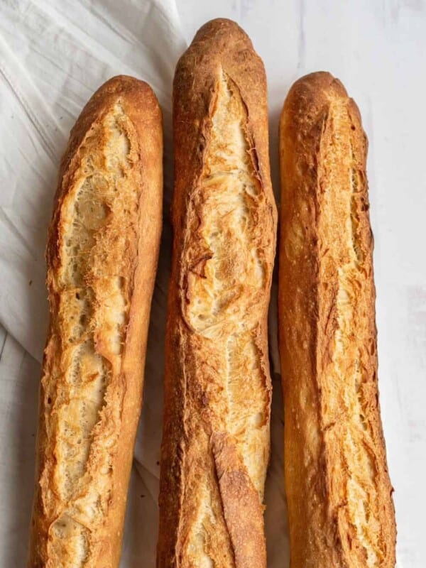 close up of three crispy golden brown baked French baguettes - just the top.