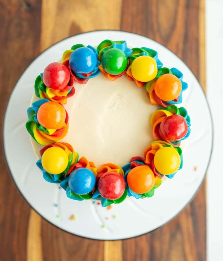 close up top view of the circle rainbow cake - it looks like a wreath of multicolored gumdrops
