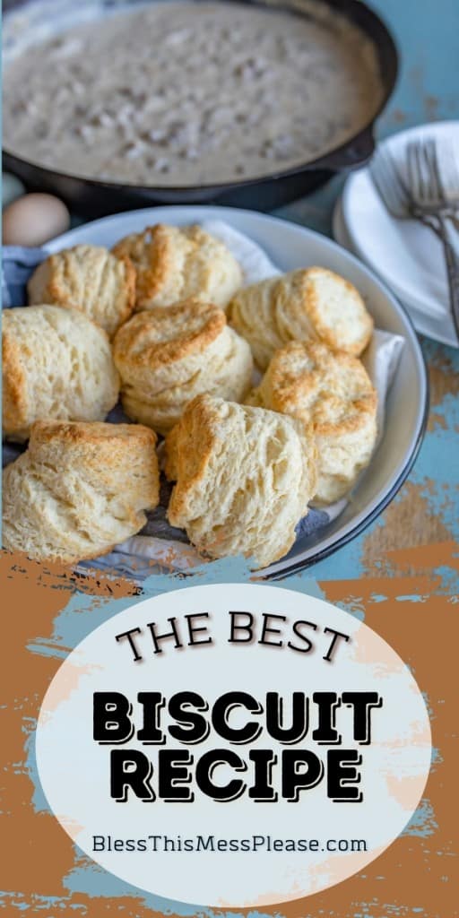 pinterest pin with title that reads "The Best Biscuit Recipe" plate of rustic homemade baked biscuit and a cast iron skillet of gravy in the background