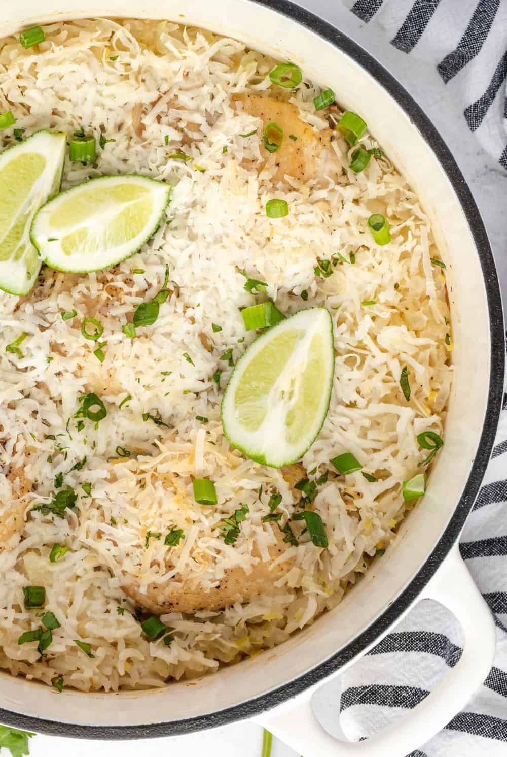 view of a white dutch oven with rice and limes