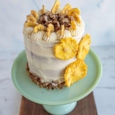 top view of the entire rustic frosted hummingbird cake on a teal stand